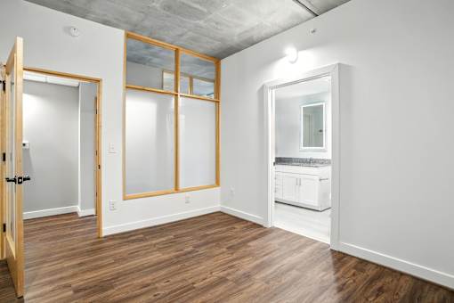 A room with a wooden floor and white walls.