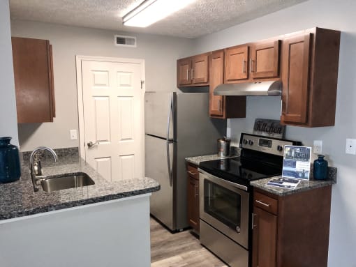 a kitchen with granite counter tops and stainless steel appliances