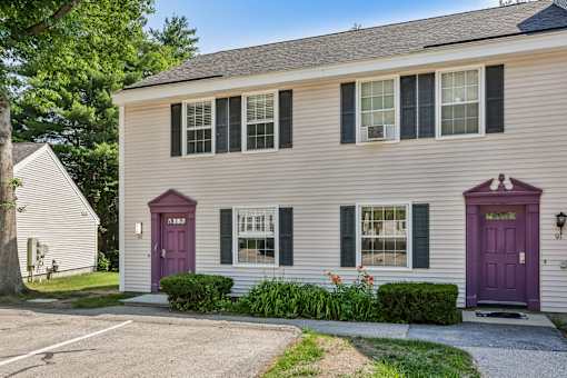 A two-story house with a purple front door.