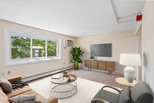 A living room with a couch, chair, and television.