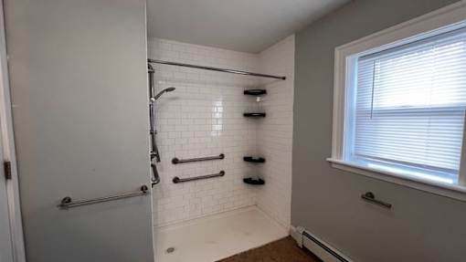 A bathroom with a white shower curtain and a white door.