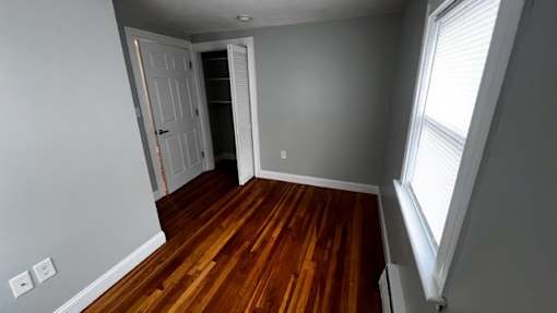 A room with wooden floors and a white door.