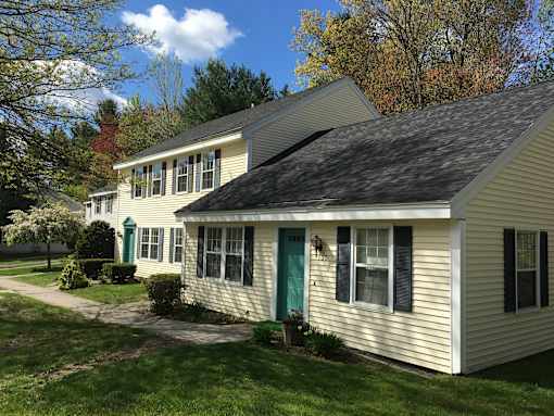 A house with a green door and black shutters.