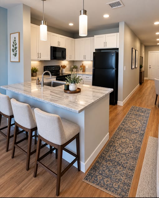 A kitchen with a black fridge and white cabinets.