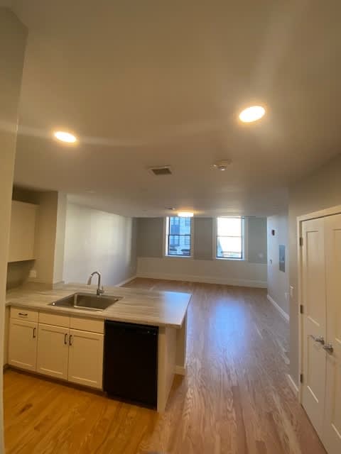 A kitchen with a sink and cabinets.
