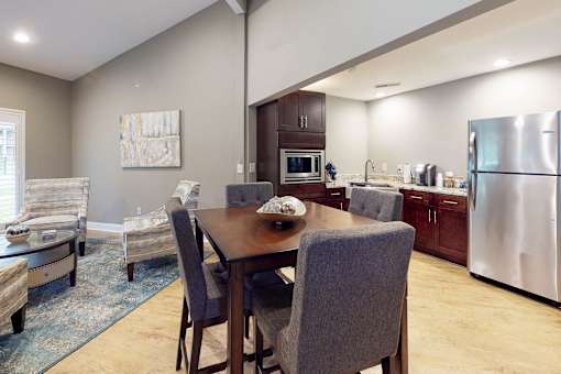 A modern kitchen with a dining table and chairs.