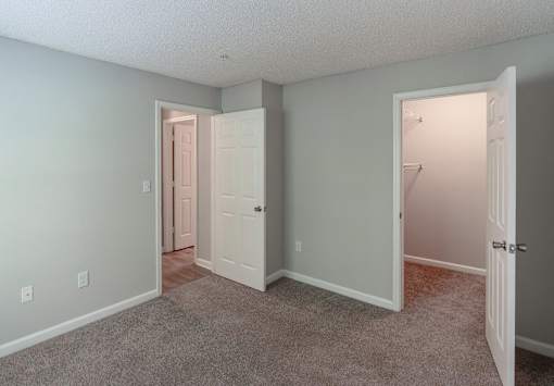 A room with two doors, one of which is open.