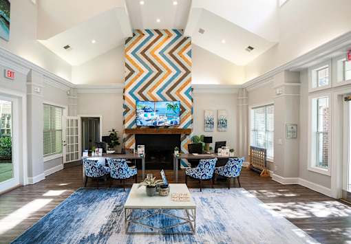 A living room with a fireplace and a large painting above it.