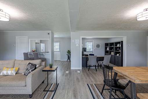 A living room with a grey couch and a wooden table.