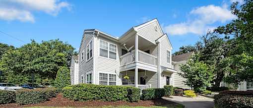 A two-story house with a balcony on the second floor.