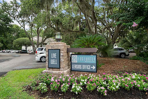 A sign for 29 Eggwater Leasing Office is in front of a flower bed.