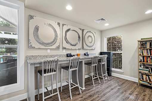 A kitchen with a bar area and a bookshelf.