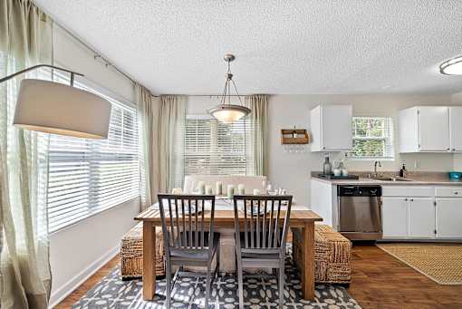 A dining room with a table set for two.