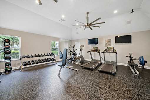 A spacious home gym with a variety of equipment including treadmills, weights, and exercise machines.