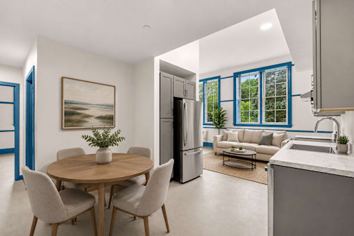 A modern kitchen with a dining table and chairs.
