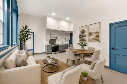 A modern living room with a dining area and kitchen in the background.
