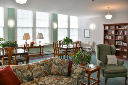 a living room filled with furniture and plants