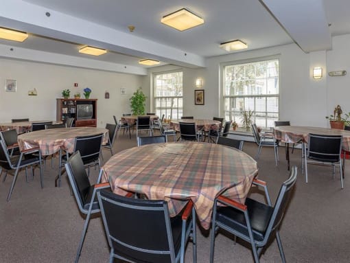 a large dining room with tables and chairs