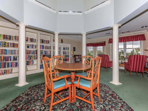 a dining room with a table and chairs in a library