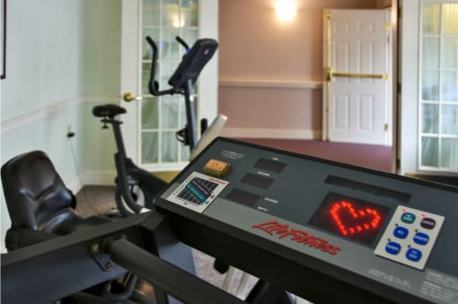 a home gym with a treadmill and exercise equipment