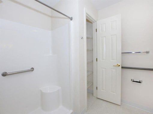 a white bathroom with a row of arrows on the wall