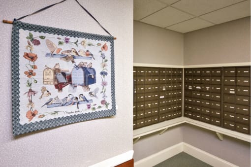 a locker room with a wall hanging with a quilt on it and a locker