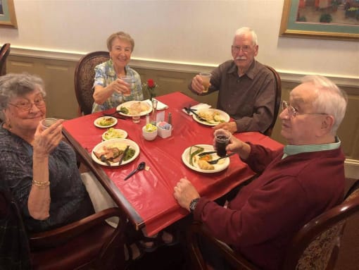 a group of people sitting around a table eating food