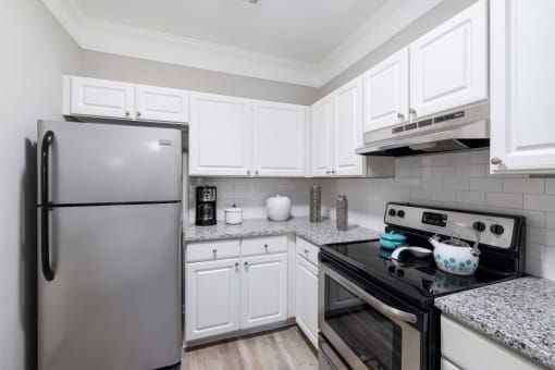 a kitchen with white cabinets and stainless steel appliances braxton brier creek raleigh nc