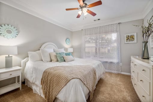a bedroom with a large bed and a ceiling fan
