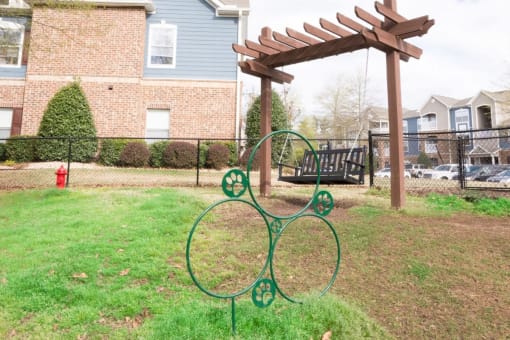 a playground with a swing set and a pergola braxton brier creek raleigh nc