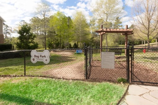 a dog park with a sign that says dog park braxton brier creek raleigh nc