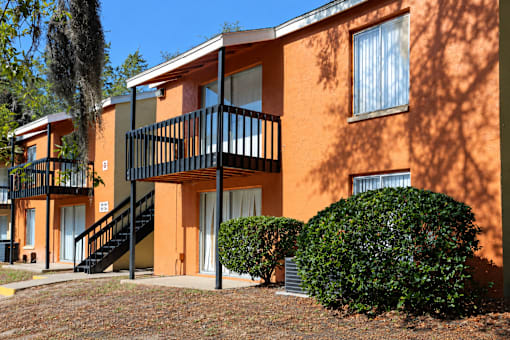 A building with orange walls and a black railing.