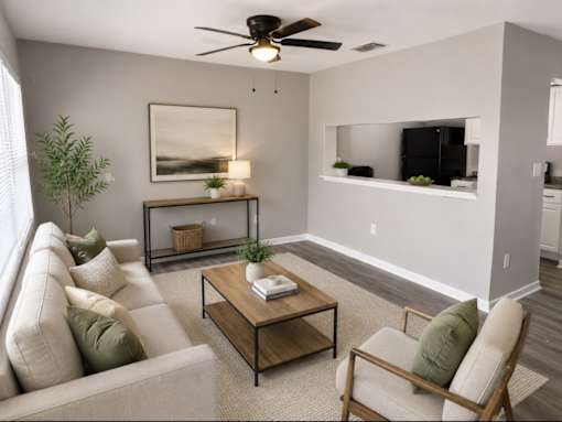 A living room with a couch, chair, and a coffee table.
