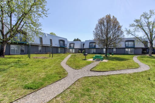 modern apartments with a courtyard with a picnic area and grass. The Highland on Briley