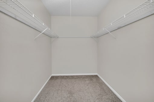 the interior of an empty room with white walls and carpet