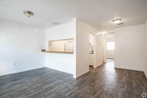 A room with a wooden floor and white walls.