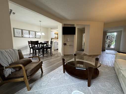 a view of a living room and dining room with a couch and a table