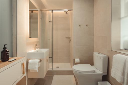 a small bathroom with a toilet and a shower at Scout Living, powered by Placemakr Apartments, Georgia 30308