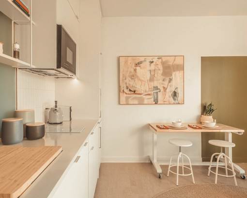 a kitchen and dining area with a table and chairs and a sink at Scout Living, powered by Placemakr Apartments, Atlanta, 30308
