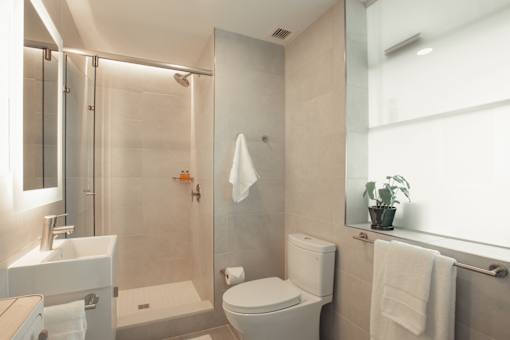a bathroom with a shower and a toilet and a sink at Scout Living, powered by Placemakr Apartments, Atlanta, GA, 30308