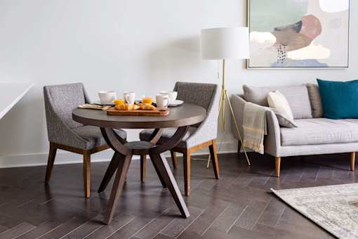 A modern dining room with a round table and chairs at The Pennsylvanian Apartments, Pittsburgh, PA