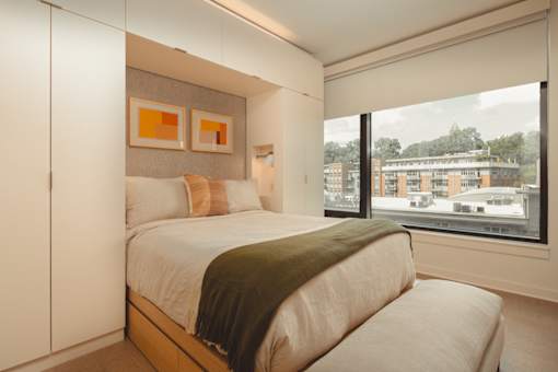 a bedroom with a bed and a large window at Scout Living, powered by Placemakr Apartments, Atlanta, Georgia