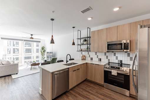 A modern kitchen with wooden cabinets and stainless steel appliances at Anthem House Apartment , Alabama, 35806