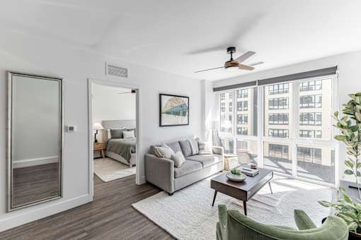 A living room with a green chair and a grey couch at Anthem House Apartment , Alabama