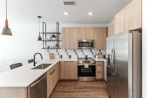 A modern kitchen with a refrigerator, sink, and microwave at Anthem House Apartment, Huntsville, AL, 35806