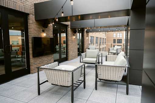 Two wicker chairs with cushions are placed on a patio at Anthem House, Huntsville, 35806