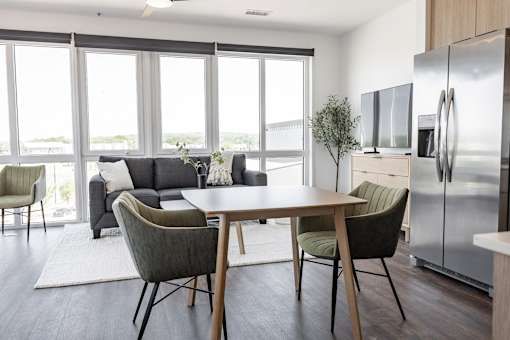 A modern kitchen with a dining table and chairs at Anthem House Apartment , Huntsville, AL