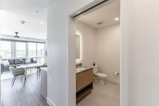 A bathroom with a toilet, sink, and a window at Anthem House Apartment, Huntsville, AL, 35806