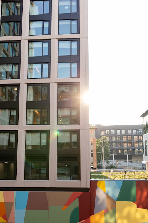 a view of a building with rainbow flags in front of it at Scout Living, powered by Placemakr Apartments, Atlanta, GA