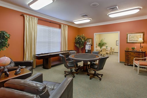 a conference room with a table and chairs and a pool table